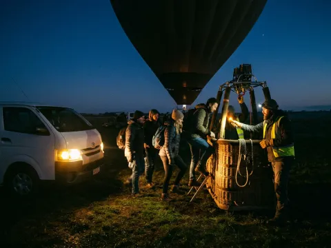 Balloon basket boarding before dawn in the Dubai desert